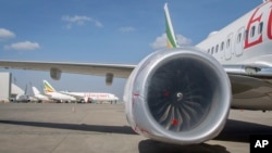 Other Ethiopian Airlines aircraft are seen in the distance behind an Ethiopian Airlines Boeing 737 Max 8 as it sits grounded at Bole International Airport in Addis Ababa, Ethiopia, March 23, 2019.