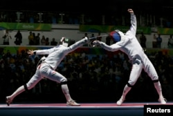 Andras Redli (HUN) of Hungary competes with Jung Jin-Sun (KOR) of South Korea in the Men's Epee Team Quarterfinals, Aug. 14, 2016.