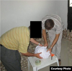 After a workshop on emergency measures to preserve cultural heritage, men prepare a collection of pots – stored in a private home – for transfer to a secure location. For the men’s safety, their faces are obscured. (Courtesy / Smithsonian Institution)
