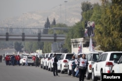A convoy consisting of Red Cross, Red Crescent and United Nation gather before heading towards Madaya from Damascus, and to al Foua and Kefraya in Idlib province, Syria, Jan. 11, 2016.