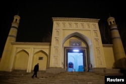 FILE - A man arrives at the Id Kah Mosque for morning prayers in Kashgar, Xinjiang Uighur Autonomous Region, China, March 23, 2017.