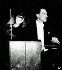 Inventor Leon Theremin playing his instrument in concert, c. 1924.