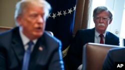 National security adviser John Bolton listens as President Donald Trump speaks during a cabinet meeting at the White House in Washington, April 9, 2018.