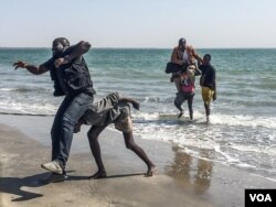 Gambian journalists Sheriff Bojang Junior (black t-shirt) and Abdoulie John (white tshirt) arrive in Banjul for the first time in years. Bojang has been in exile since 2007 and John since 2013 - this is their fist time being home in years.