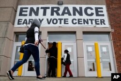 FILE - Voters arrive to vote early at the Franklin County Board of Elections, Oct. 31, 2018, in Columbus, Ohio.