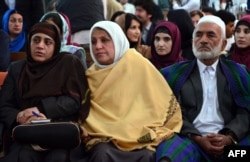 FILE - Relatives of Afghan woman, 27-year-old Farkhunda, who was beaten to death by a mob, attend a hearing at a court in Kabul on May 6, 2015. Four Afghan men were sentenced to death for the savage lynching of a woman falsely accused of blasphemy.
