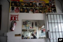 Haitian immigrant Kenson is pictured inside his barbershop in Tijuana, Mexico, Nov. 22, 2018.