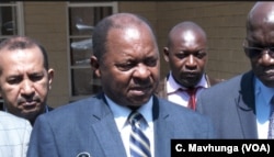 Zimbabwe's new health minister, Obadiah Moyo, tells reporters cholera that poor water supply, blocked sewers, and a failure to collect waste were making a cholera outbreak in the capital, Sept. 11, 2018.