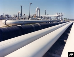 An undated photo provided by the Energy Department shows crude oil pipelines near Freeport, Texas.