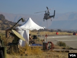 Two controllers on the ground put the K-MAX unmanned chopper through its paces. (Credit: Tom Banse)