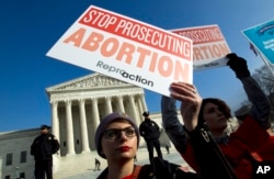 FILE - Abortion rights activists protest outside of the U.S. Supreme Court, during the March for Life in Washington, Jan. 18, 2019.