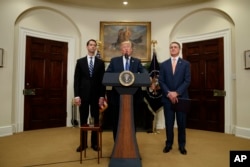 President Donald Trump, flanked by Sen. Tom Cotton, R- Ark., left, and Sen. David Perdue, R-Ga., speaks in the Roosevelt Room of the White House in Washington, Aug. 2, 2017, during the unveiling of legislation that would place new limits on legal immigrats.