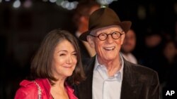 John Hurt and wife Anwen Rees-Myers pose for photographers upon arrival at the premiere of the film "Suffragette," which is also the opening gala of the London film festival in London, Oct. 7, 2015.