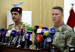 U.S. Army Col. Ryan Dillon, spokesman for Operation Inherent Resolve, the U.S.-led coalition against the Islamic State group, right, and Iraq armed forces spokesman Gen. Yahyah Rasul hold a press conference in Baghdad, Iraq, Thursday, Sept. 21, 2017.