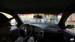Drivers approach a gas station after waiting in line for almost 24 hours in San Cristobal, Venezuela, Feb. 13, 2019.