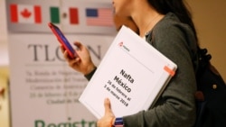 A member of the Mexican NAFTA negotiation team checks her phone during a lunch break in Mexico City, Mexico, Feb. 28, 2018.