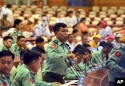 Lawmakers, including appointed military representatives, prepare to participate in the inaugural session of Myanmar's lower house parliament, Feb. 1, 2016 in Naypyitaw, Myanmar.