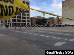 Law enforcement personnel investigate a mass shooting scene after an attack that killed and wounded Dallas police officers, in Dallas, Texas, July 8, 2016.