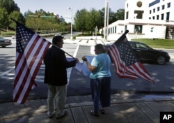 William Gheen, left, president of the political action committee ALIPAC, protests near a fundraiser for Gov. Rick Perry in Charlotte, North Carolina, Sept. 29, 2011. The group was protesting Perry's support of in-state tuition for illegal aliens.