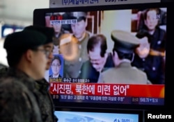 FILE - South Korean soldiers walk past a television showing reports on the execution of Jang Song Thaek. Thaek was executed for allegedly plotting a military coup.