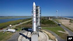 This image provided by NASA shows the Lunar Atmosphere and Dust Environment Explorer aboard a Minotaur V rocket after a rollout at NASA's Wallops Island test flight facility in Wallops Island, Va., Sept. 5, 2013.