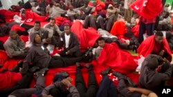 Migrants rest inside a sports center after they were rescued by the sea rescue service at the Strait of Gibraltar near the coast of Tarifa, southern Spain, Aug. 12, 2014. 