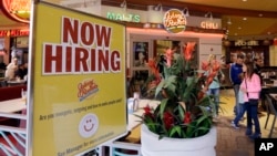 FILE - А restaurant posts a sign indicating it is hiring, in Miami, Feb. 9, 2016.