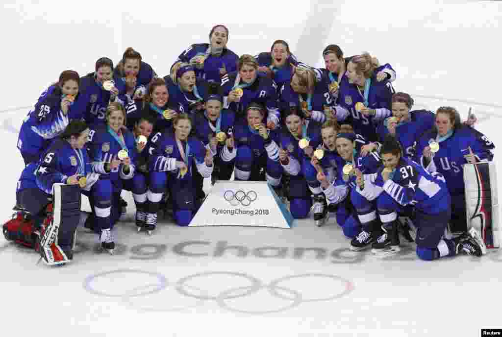 Team USA players hold up their gold medals as they pose after winning their game in the women's gold medal hockey game in Gangneung, South Korea, Feb. 22, 2018.