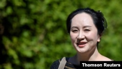 FILE - Huawei Technologies Chief Financial Officer Meng Wanzhou leaves her home to attend a court hearing in Vancouver, British Columbia, in June 2020.