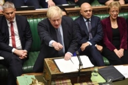 FILE - Britain's Prime Minister Boris Johnson speaks to lawmakers inside the House of Commons to update details of his new Brexit deal with EU, in London, Oct. 19, 2019.
