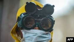 A cleaner wears protective gear to disinfect public transit as a preventive measure against the spreading of the COVID-19 coronavirus in Addis Ababa, Ethiopia, on March 20, 2020.