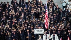 Athletes from the United States of America walk during the opening ceremony in the Olympic Stadium at the 2020 Summer Olympics, July 23, 2021, in Tokyo, Japan.