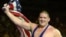 Rulon Gardner waves the American flag following his gold medal win against three-time Olympic gold medalist Alexandre Kareline, of Russia, in the Greco-Roman 130 kg final wrestling match at the XXVII Summer Games in Sydney, 27 Sep 2000 (file photo)