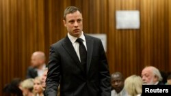 FILE - South African Olympic and Paralympic track star Oscar Pistorius attends his sentencing at the North Gauteng High Court in Pretoria, October 21, 2014.