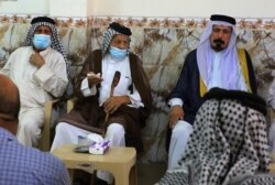 Iraqis attend a funeral for an Iraqi family killed in an explosion a day earlier in a popular market in the Shiite-majority Sadr City neighborhood on July 20, 2021.