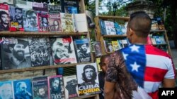FILE - A Cuban man wearing a T-shirt with the U.S. flag walks along a street in Havana, Jan. 16, 2015. 