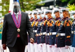 FILE - United States Defense Secretary Lloyd Austin views the military honor guard at Camp Aguinaldo military camp in Quezon City, Metro Manila, Philippines.