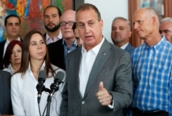 Representative Mario Diaz-Balart, center, R-Fla., speaks to members of the media after he, Sen. Marco Rubio, R-Fla., and Sen. Rick Scott, right, R-Fla., met with Venezuelan, Colombian and Cuban community leaders, May 3, 2019.