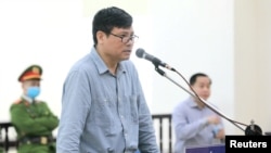 Blogger and former journalist Truong Duy Nhat is seen during his trial at a court in Hanoi, March 9, 2020. 