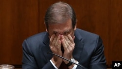 Portuguese Prime Minister Pedro Passos Coelho rubs his eyes during the debate of the government's four-year policy program at the Parliament in Lisbon, Nov. 10, 2015. 