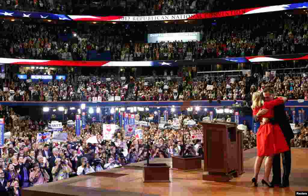 Ann Romney hugs her husband after she addressed delegates during the second session of the Republican National Convention, August 28, 2012.