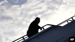 U.S. Secretary of State Mike Pompeo boards a plane before departing from London Stansted Airport, north of London, May 9, 2019. 