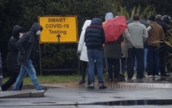 People queue at a testing center amid the outbreak of the coronavirus disease, in Southport, Britain, Feb. 2, 2021.