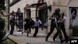 Kenyan security forces help people escape after a blast at Dusit D2 hotel in Nairobi, Kenya, Jan. 15, 2019. A blast followed by a gun battle rocked the hotel and office complex in Nairobi, causing casualties, in an attack claimed by the Al-Qaida-linked Al-Shabab Islamist group.