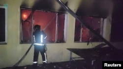 A member of Ukraine's emergency services works at the site of a Russian drone attack in a location given as Odesa, Ukraine, in this handout image released March 5, 2024. (Defence Forces Southern Ukraine/Handout via Reuters). 