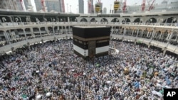 FILE - Muslim pilgrims circle the Kaaba, the cubic building at the Grand Mosque in the Muslim holy city of Mecca, Saudi Arabia, Saudi Arabia, Sept. 20, 2015. 