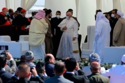 Pope Francis, center, prepares to leave after an inter-religious meeting near the archaeological site of Ur, near Nasiriyah, Iraq, March 6, 2021.
