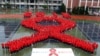 A red ribbon, the symbol of the worldwide campaign against AIDS.