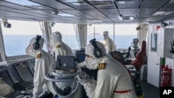 FILE - In this photo provided by the British ministry of defense, members of the HMS Diamond's Bridge team shoot down a missile fired by Houthi rebels from Yemen, April 24, 2024. 