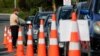 FILE - Motorists wait to take a COVID-19 test at a drive through community based assessment centre in Christchurch, New Zealand, Aug. 13, 2020. 